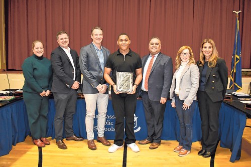 Manhasset senior Jordan Gardner (middle) received the William A. Shine Award during the Manhasset Public Schools Board of Education meeting. Pictured with the Manhasset Board of Education and Superintendent of Schools Dr. Gaurav Passi (third from right).