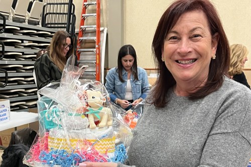 BirthdayWishes_C POB’s Cheryl Dender with a sample diaper “cake” made at the event.