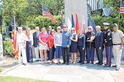 Elected officials and local veterans gathered on Memorial Day, honoring Dennis B. Murray, the brother of Shawn Murray and Carol 
Murray Bonanza, center, as well as Glen Cove Memorial Day Grand Marshall SSgt. Cherise S. Herrera, second to right. (Photo by Jennifer Corr)