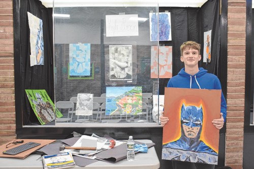 SCHOOLS_art_022124_C Senior Kyle Brown with his exhibit for the IB Art Talks program at Locust Valley High School. (Photos courtesy Locust Valley Central School District)