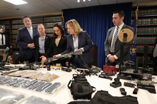 SecurityGuard_B Queens District Attorney Melinda Katz showing the arsenal of homemade bombs and ghost guns found in an Astoria apartment. (Photo from the Queens District Attorney Melinda Katz’s Facebook)