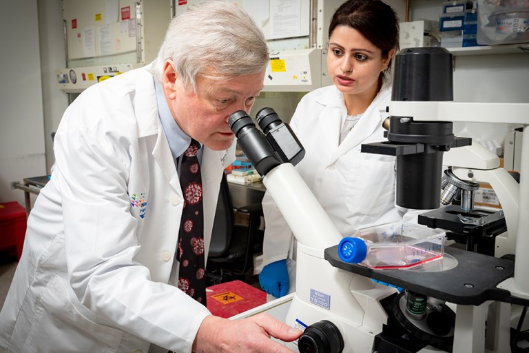 Dr. Peter Gregersen examines a sample.