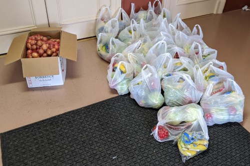 St. Aloysius and Temple Beth-El Brotherhood volunteers separate $1,200 worth of fresh produce into 90 to 100 bags for community members in need every two weeks. (Contributed photo)