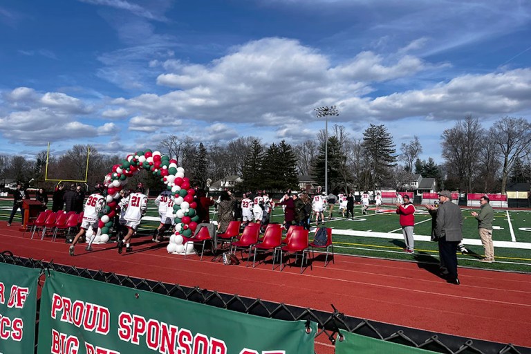 GC_ribboncutting_032724_A The boys lacrosse team runs onto the newly completed synthetic turf to play its first ever game. (Photos by Jennifer Corr)