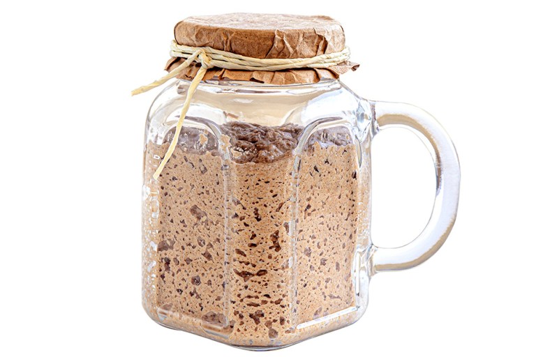 Active sourdough starter in glass jar. Rye leaven for bread isolated on white background. Bread baking concept. Active sourdough starter in glass jar. Rye leaven for bread isolated on white background. Traditional bread baking concept. (Getty Image)