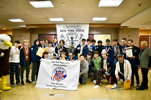 HockeyChamps_A The Bethpage High School boys hockey team, along with their coaches Jeff Schmier and Anthony Regateiro, were recognized by Nassau County Legislator Rose Walker (right). (Contributed photo)