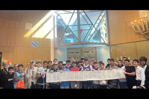 Back row from the left: Rabbi Dr. Jeffrey Kobrin, NSHA Head of School; Cantor Yitzy Spinner, Ashkenazic Megillah Instructor; Dr. Paul Brody, Megillah Program initiator, holding Megillah case; and NSHA Middle School 2024 Megillah Readers, in Purim costumes, proudly unfurling the “Dr. Paul Brody Megillah”. At the far right, Rabbi Simon Basalely, Middle School Judaic Studies Principal and Sephardic Megillah instructor.
(Photo from NSHA Photo File)