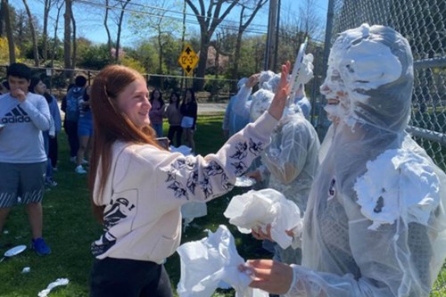 RaiseDough_A Roslyn Middle School staff taking a pie in the face for a good cause. (Contributed photo)