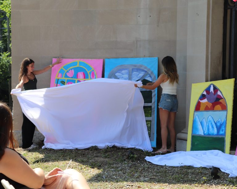 EstateArt_Cover Isabella Santos (left) and Hannah Bailey (right) unveil new art for the Lodge. (Photo credit Erica Schwartz)
