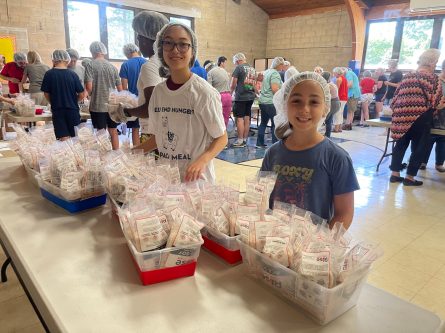 Fighting Hunger_B With trays of food ready to go, it's all smiles from our youth volunteers (Photos from Resurrection Lutheran Church)