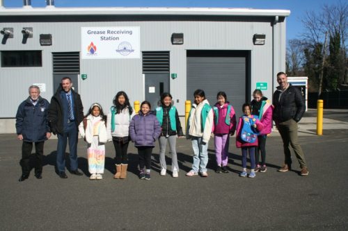 GirlScoutTour_A Great Neck Water Pollution Control District Chairman Steve Reiter, far left, Commissioner Mark Berger and Superintendent Christopher Murphy, far right, guided Girl Scouts Troop 612 on an in-depth tour of the GNWPCD facility. (Contributed photo)