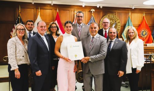 Lauren O’Brien (center, left) alongside Town Supervisor Joseph Saladino (center, right) and his colleagues. (Photo courtesy of the Town of Oyster Bay)