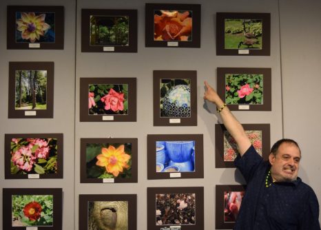 An artist proudly points to his work. (Photos courtesy of ACLD)