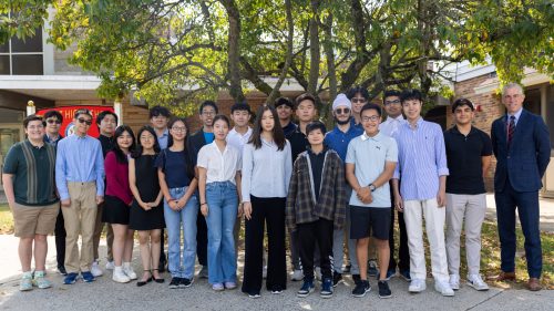 (1) SCSD Merit Semifinalists The district's 21 National Merit semifinalists stand with district Superintendent Thomas Rogers (Photo provided by the Syosset Central School District)