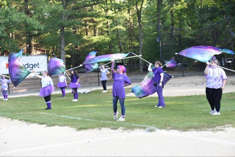 The Dalerguard swirls their flags in harmony with the music. (Photo credit Farmingdale School District)