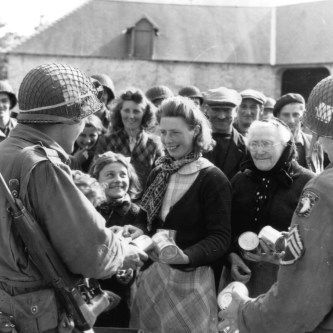 GIs giving canned goods in Heisville, France (Courtesy of Christian Taylor)