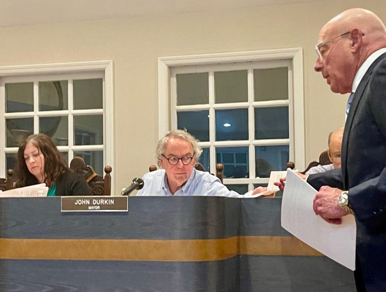 Village of Roslyn Mayor John Durkin reviews proposal materials from the applicant (Photo by Julie Prisco)