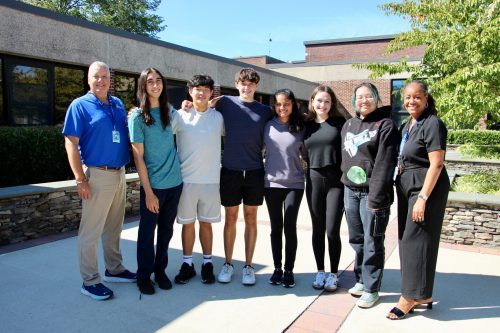 merit scholars Principal Dr. Scott Andrews and Tanya Baptiste with the 2025 National Merit Scholarship
semifinalists (Photo provided by the Roslyn School District)