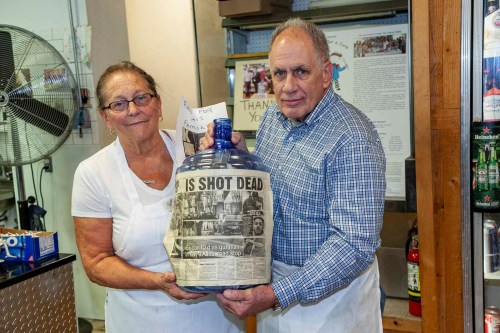 Rachel Collura, left and Ron Collura, right, with a five-gallon jug full of donations (Photo by Peter M. Budraitis)