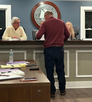 Schroeder shows the board the tentative layout of the upgraded courts. (Photo credit Lauren Feldman)