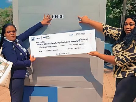 Irma Jeanty, Program Director of Glen Cove EOC (left), and GEICO employee Cheron Jackson (right) proudly display a $15,000 check from the GEICO Philanthropic Foundation (Photo provided by Gaitley Stevenson-Mathews)
