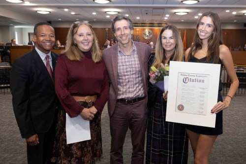 Pictured from left to right, Legislator Carrié Solages, Legislator Delia DeRiggi-Whitton, Mazzy Sass' parents and Mazzy Sass (Photo by Peter M. Budraitis)
