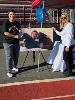Pictured left to right, Dog Rescue Club co-advisor Dana Kaplan and Mara Navaretta with a photo of Sabrina at this year's walk-a-thon (Photo provided by TSabrina Navaretta Memorial Foundation)